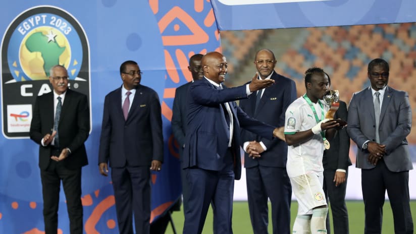 Samba Diallo of Senegal receive a trophy from Patrice Motsepe President of the Confederation of African Football during the 2023 Africa Cup of N